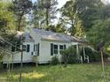 Cozy home with green shutters, surrounded by trees, and a spacious yard at 529 Sunset Dr, Fuquay Varina, NC 27526