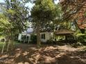 Charming home surrounded by mature trees and features a covered carport at 529 Sunset Dr, Fuquay Varina, NC 27526