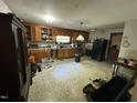 Open kitchen features wood cabinets and a black refrigerator at 529 Sunset Dr, Fuquay Varina, NC 27526