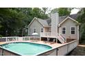 Outdoor space featuring a fenced pool area with a large deck and outdoor furniture at 5600 Treestand Ct, Garner, NC 27529