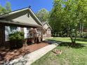 A well-maintained front yard complements the brick and siding exterior of this inviting home at 5600 Treestand Ct, Garner, NC 27529