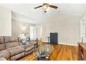 Spacious living room with vaulted ceilings, hardwood floors, and a comfortable seating area at 5860 Andover Dr, Graham, NC 27253
