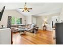Open living room with hardwood floors, vaulted ceiling, and lots of natural light at 5860 Andover Dr, Graham, NC 27253