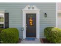 Elegant black front door with decorative trim, enhancing the entrance with charm and style at 612 Spring Meadow Dr, Durham, NC 27713