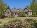 Charming stone-accented home with a well-manicured lawn and a inviting front porch at 6824 Wood Forest Dr, Cary, NC 27519