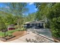 Beautiful blue home with a well-manicured lawn and mature trees at 7653 Summerglen Dr, Raleigh, NC 27615