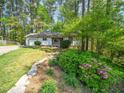 Inviting home exterior with mature landscaping and a stone-lined flower bed, offering great curb appeal at 7716 Bluff Top Court Ct, Raleigh, NC 27615