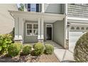 Charming front porch with white pillars, stone accents, and a welcoming black door at 7728 Cape Charles Dr, Raleigh, NC 27617