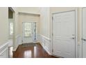 Bright foyer with hardwood floors, wainscoting, and a glass-paneled door at 792 Eldridge Loop, Cary, NC 27519