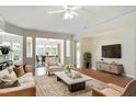 Spacious living room with hardwood floors, a ceiling fan, and an open floor plan to the dining area at 792 Eldridge Loop, Cary, NC 27519