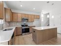Spacious kitchen featuring stainless steel appliances, light wood cabinets, and a center island at 90 Cordoba Dr, Franklinton, NC 27525