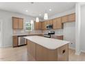 Spacious kitchen featuring stainless steel appliances, light wood cabinets, and a center island at 90 Cordoba Dr, Franklinton, NC 27525