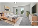 Bright bedroom with natural light, plush carpet, and stylish furniture at 103 Loch Ryan Way, Cary, NC 27513