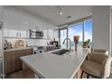 Modern kitchen features stainless steel appliances, white cabinets and counter seating at 110 N Corcoran St # 2101, Durham, NC 27701
