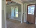 Bright entryway with a large window and a classic wood door, awaiting finishing touches at 11226 Old Beulah Rd, Kenly, NC 27542