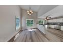 Inviting dining area with hardwood floors, stylish chandelier, and adjacent kitchen, offering a seamless flow for entertaining at 113 Union Mills Way, Cary, NC 27519