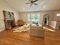 Inviting living room featuring a stone fireplace and lots of natural light at 131 Rosewood Dr Dr, Roxboro, NC 27573