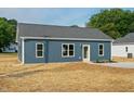 Side view of single story home featuring minimalist landscaping at 19 Southern Village Dr, Roxboro, NC 27573