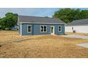 View of single story home featuring a concrete driveway and minimalist landscaping at 19 Southern Village Dr, Roxboro, NC 27573