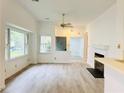 Bright living room with wood flooring, a fireplace, and large windows for natural light at 203 Standish Dr, Chapel Hill, NC 27517