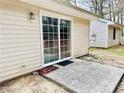Back patio area featuring a sliding glass door and a concrete slab at 203 Standish Dr, Chapel Hill, NC 27517