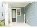 Inviting front porch with a black door and 'Welcome' sign at 2089 Florine Dr, Apex, NC 27502