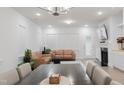 Bright living room features tan leather couches, fireplace and hardwood floors at 2089 Florine Dr, Apex, NC 27502