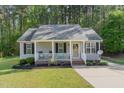 Charming single-story home with a cozy front porch and well-maintained landscaping at 2112 Ballston Pl, Knightdale, NC 27545