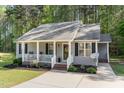 Inviting front porch with a seating area and a decorative wreath on the front door at 2112 Ballston Pl, Knightdale, NC 27545