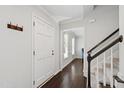 Bright entryway featuring hardwood floors, a staircase, and an open doorway to another room at 213 Beechtree Dr, Cary, NC 27513