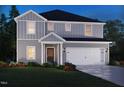 Charming two-story home with gray siding, white trim, covered porch, and a two car garage at 2218 Cherry Creek Rd, Haw River, NC 27258