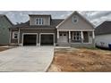 Charming two-story home showcasing a spacious two-car garage and inviting front porch at 2320 Eagle Shot Ct # 20, Fuquay Varina, NC 27526