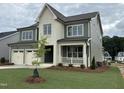 Beautiful two-story home showcasing manicured lawn, two-car garage, and welcoming covered porch at 2324 Eagle Shot Ct # 19, Fuquay Varina, NC 27526