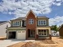 Inviting two-story home with a two-car garage and beautiful exterior accents at 2324 Eagle Shot Ct # 19, Fuquay Varina, NC 27526