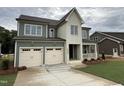 Two-story home features a two-car garage, covered porch, and nicely landscaped front yard at 2324 Eagle Shot Ct # 19, Fuquay Varina, NC 27526