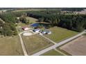 Aerial view of a property with pond, barn, horse ring, outbuildings, and house at 2747 Beasley, Benson, NC 27504