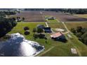 Aerial shot showing a pond, large field, house and barn with rural acreage at 2747 Beasley, Benson, NC 27504