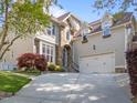 Charming exterior of two-story home with a stone entryway and attached garage on a tree-lined lot at 2817 Peachleaf St, Raleigh, NC 27614