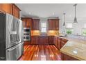 Gourmet kitchen with stainless steel appliances, custom cabinets, hardwood floors, and granite countertops at 2817 Peachleaf St, Raleigh, NC 27614