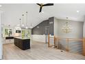 Spacious kitchen with a vaulted ceiling, modern pendant lighting, an island, stainless appliances and hardwood floors at 313 Crown Oaks Dr, Raleigh, NC 27615