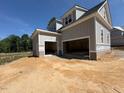 A spacious attached garage with two large doors, providing ample parking and storage for vehicles and equipment at 348 Inspiration Way, Fuquay Varina, NC 27526