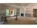 A spacious living room with fireplace and sliding glass doors leading to a deck with a view to the outside at 348 Inspiration Way, Fuquay Varina, NC 27526