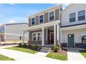 View of a well-maintained home with a cozy front porch, showcasing its inviting curb appeal and modern design at 3715 Rosebush Dr, Zebulon, NC 27597