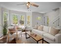 Bright living room with natural light, wood floors, and stylish furnishings at 4936 Liverpool Ln, Raleigh, NC 27604