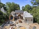 A new construction home with brick and stone accents and metal roof in a treed neighborhood at 516 Transylvania Ave, Raleigh, NC 27609