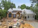 New construction showing brick and stone exterior with architectural details under a blue sky at 516 Transylvania Ave, Raleigh, NC 27609