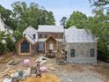 New construction showing brick and stone exterior with architectural details under a blue sky at 516 Transylvania Ave, Raleigh, NC 27609