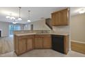 Inviting kitchen featuring stainless steel sink, a breakfast bar, and black appliances at 5329 Big Bass Dr, Raleigh, NC 27610