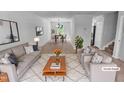 Stylishly staged living room with an open floor plan into dining area, perfect for modern living at 5600 Brandycrest Dr, Raleigh, NC 27610