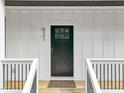 Inviting front door with modern hardware, set in a white frame and complemented by a 'Welcome' mat at 621 Bon Air Ave, Durham, NC 27704